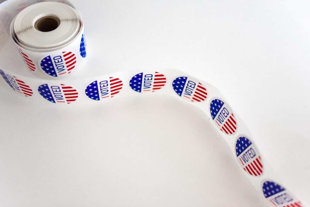 Voted sticker with american flag design in a sticker roll