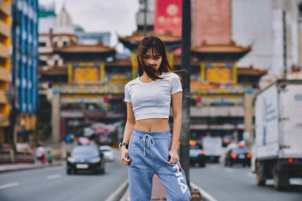 woman standing on the road wearing cropped shirt