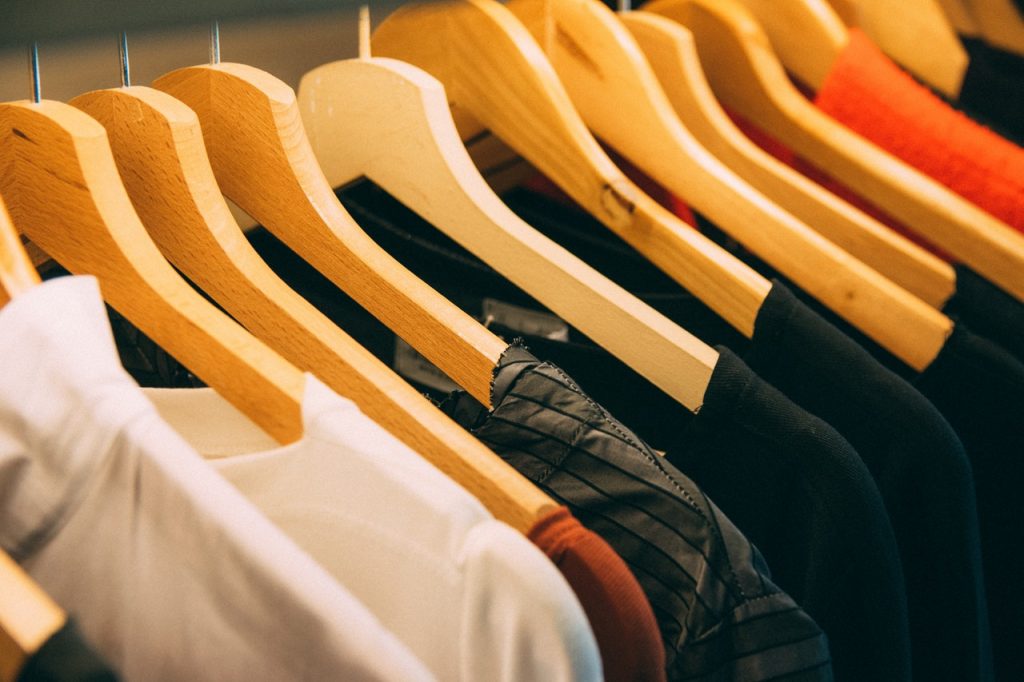 shirts placed in hangers on a rack